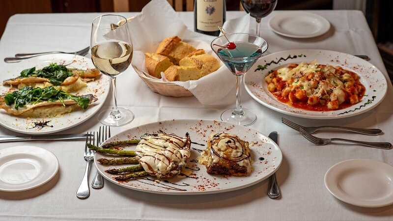 Multiple entrees with focus on filet mignon entree with mashed potatoes and asparagus